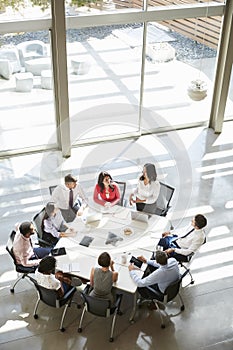 Businesswoman addressing meeting, elevated view, vertical photo