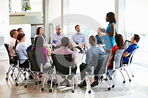 Businesswoman Addressing Multi-Cultural Office Staff Meeting