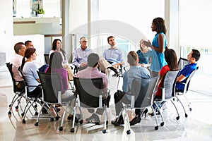 Businesswoman Addressing Multi-Cultural Office Staff Meeting photo