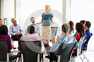 Businesswoman Addressing Multi-Cultural Office Staff Meeting photo