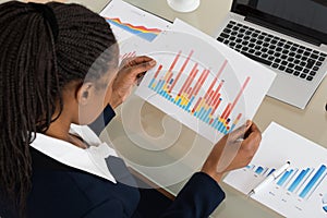 Businesswoman Analyzing Colorful Bar Graph