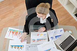 Businesswoman Analyzing Financial Graphs