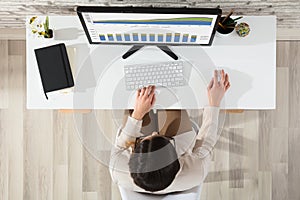 Businesswoman Analyzing Graph Using Computer