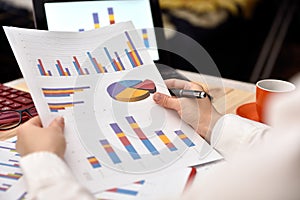 Businesswoman analyzing income graphs and charts