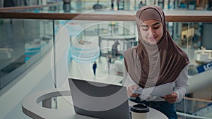 Businesswoman arabian islamic woman in hijab working with business contract paper report documents enter data at