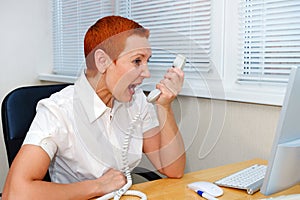 Businesswoman arguing with a client on the phone. Disagreements, misunderstandings. Stress, scandal