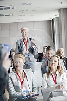 Businesswoman asking questions during seminar