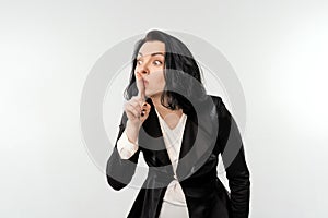 Businesswoman Asking For Silence, keeping a secret, standing over white background. Achievement career wealth, business concept