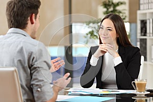 Businesswoman attending a client at office photo