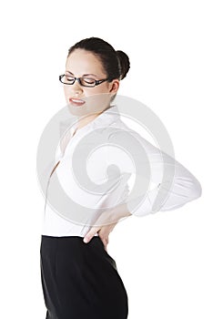 Businesswoman with back ache after long work.