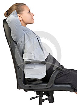 Businesswoman back in office chair with hands