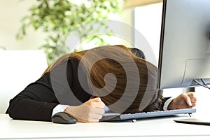 Businesswoman banging the head against the table photo