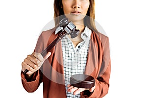 Businesswoman banging a law hammer on the gavel