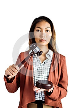 Businesswoman banging a law hammer on the gavel