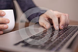 Businesswoman at the bar working on  laptop hands close up