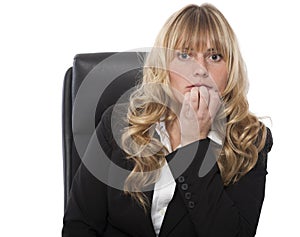 Businesswoman biting her nails in trepidation