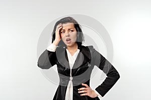 Businesswoman in black formal jacket white shirt looking dejected, standing over white background. Small business owners, women
