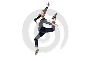 Businesswoman in black formal wear dancing isolated on white