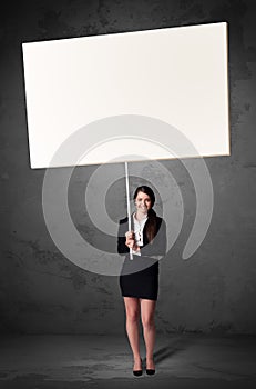 Businesswoman with blank whiteboard