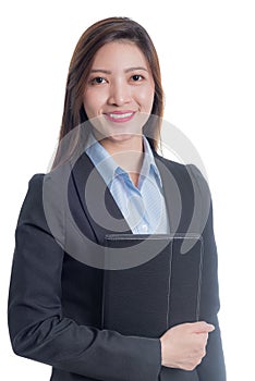 A businesswoman in a blue shirt and gray suit is holding a black notebook with a smiling face