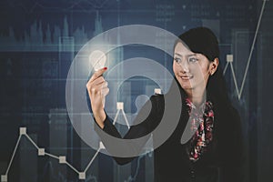 Businesswoman with bright bulb and growth graph