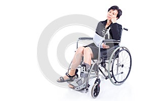 Businesswoman with broken arm and leg sitting on wheel chair