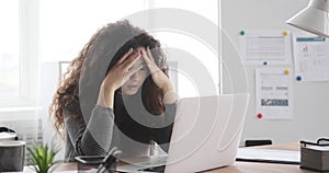 Businesswoman broken after receiving bad news on laptop