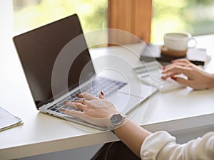 Businesswoman browsing the internet on notebook laptop computer