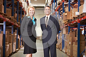 Businesswoman And Businessman In Distribution Warehouse