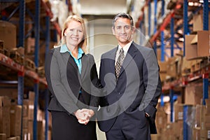 Businesswoman And Businessman In Distribution Warehouse