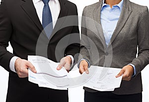 Businesswoman and businessman with files and forms