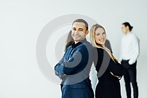 Businesswoman and businessman on the foreground of his collegues