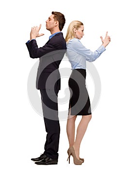 Businesswoman and businessman with imaginary guns