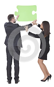 Businesswoman and businessman keeping puzzle piece