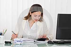 Businesswoman Calculating Bills