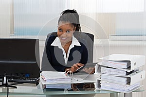 Businesswoman Calculating Bills