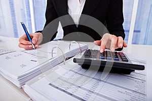 Businesswoman calculating tax photo