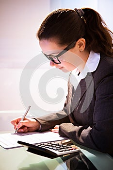 Businesswoman Calculating Tax