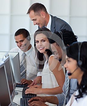 Businesswoman in a call center with her team