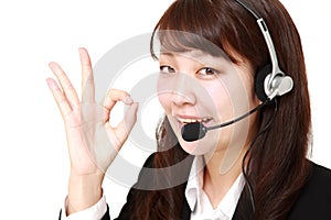 Businesswoman of call center showing perfect sign