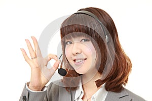 Businesswoman of call center showing perfect sign
