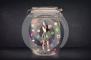 Businesswoman captured in a glass jar with colourful app icons c