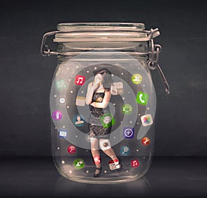 Businesswoman captured in a glass jar with colourful app icons c