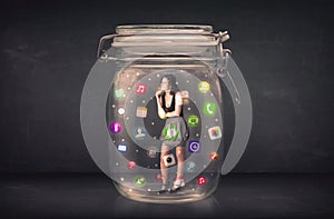 Businesswoman captured in a glass jar with colourful app icons c