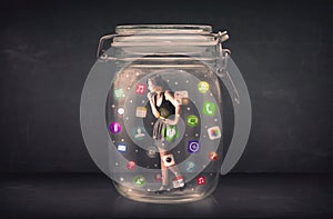 Businesswoman captured in a glass jar with colourful app icons c