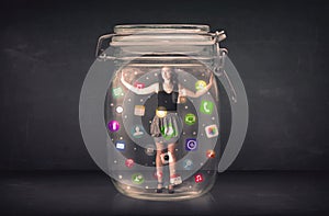 Businesswoman captured in a glass jar with colourful app icons c