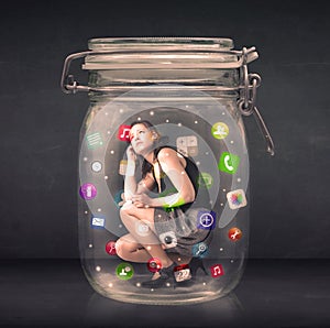 Businesswoman captured in a glass jar with colourful app icons c