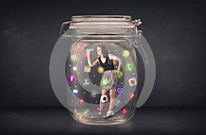 Businesswoman captured in a glass jar with colourful app icons c