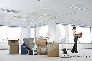 Businesswoman Carrying Carton In New Office