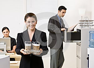 Businesswoman carrying tray of coffee photo
